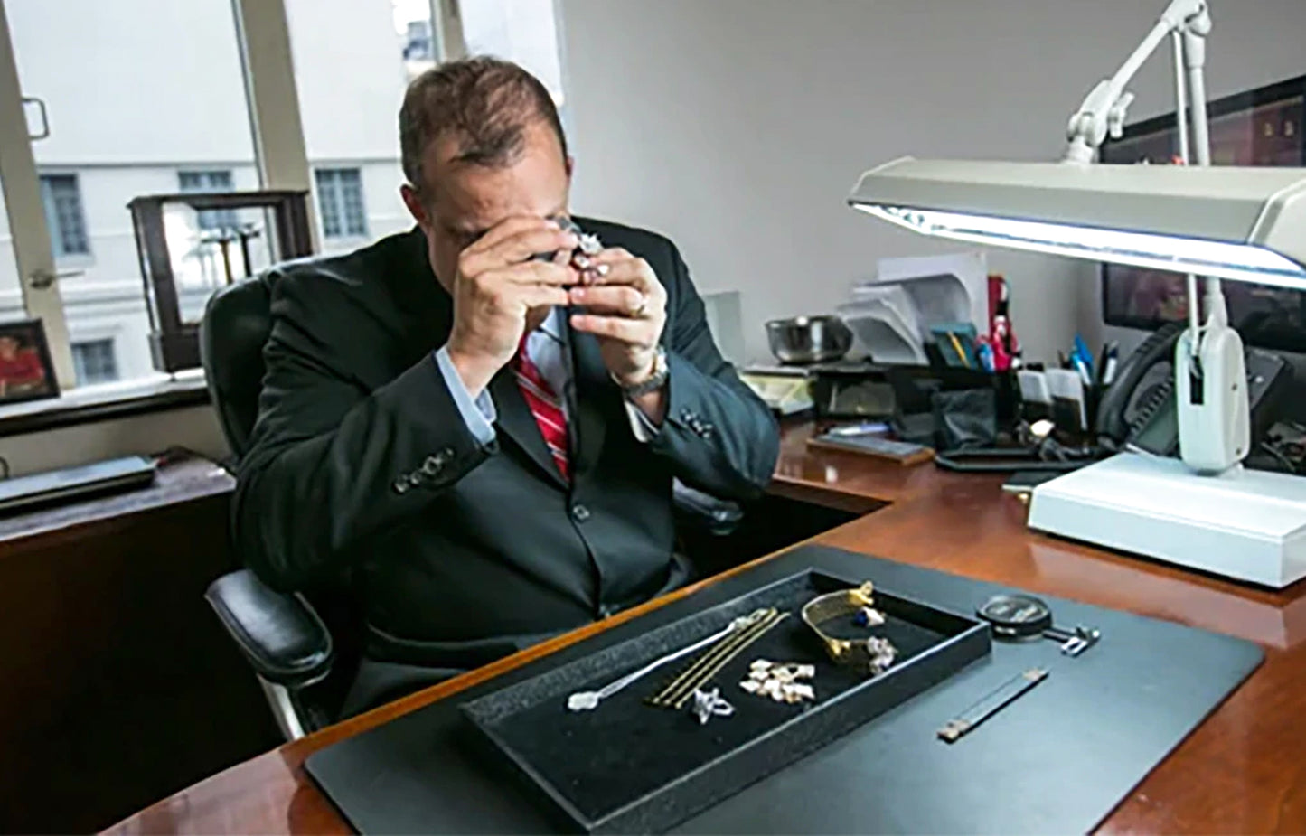 Andrew Fabrikant examining Jewelry